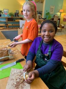 Elementary Girls Helping to Peel Potatoes